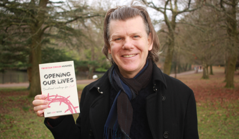 The Revd Dr Trystan Owain Hughes holding up his Lent book, Opening our Lives