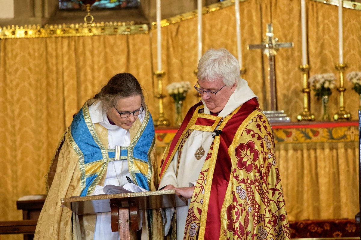 Bishop June and Bishop Karin signing a document