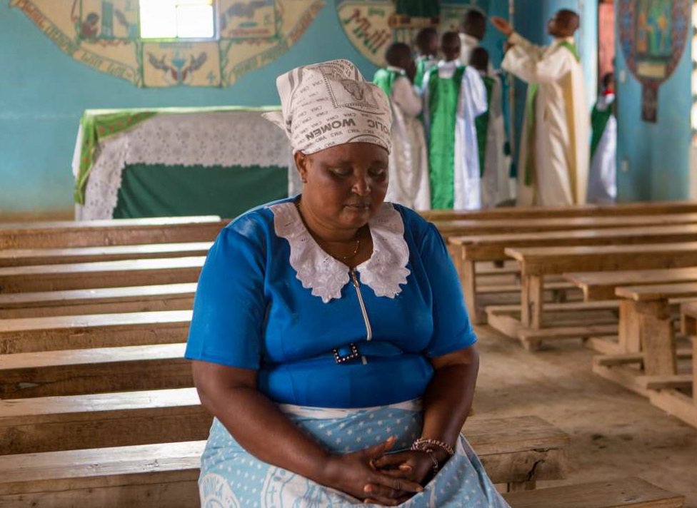 Woman praying in Kenya