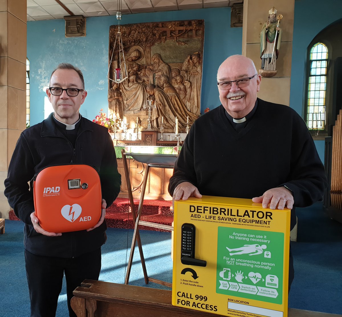 Fr Edward Owen and Fr Jeff Williams with defibrillator