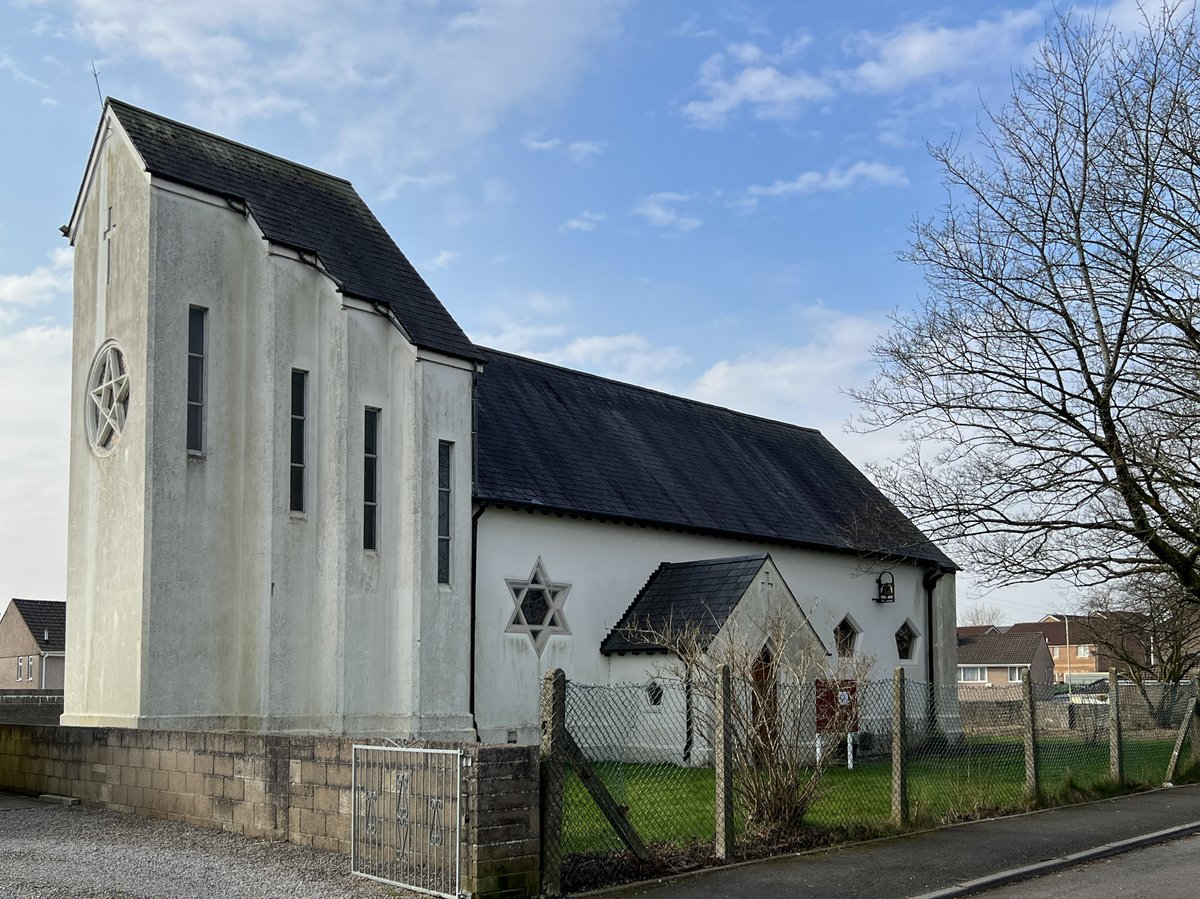 View of St Michael Beddau, a modern whitewashed building