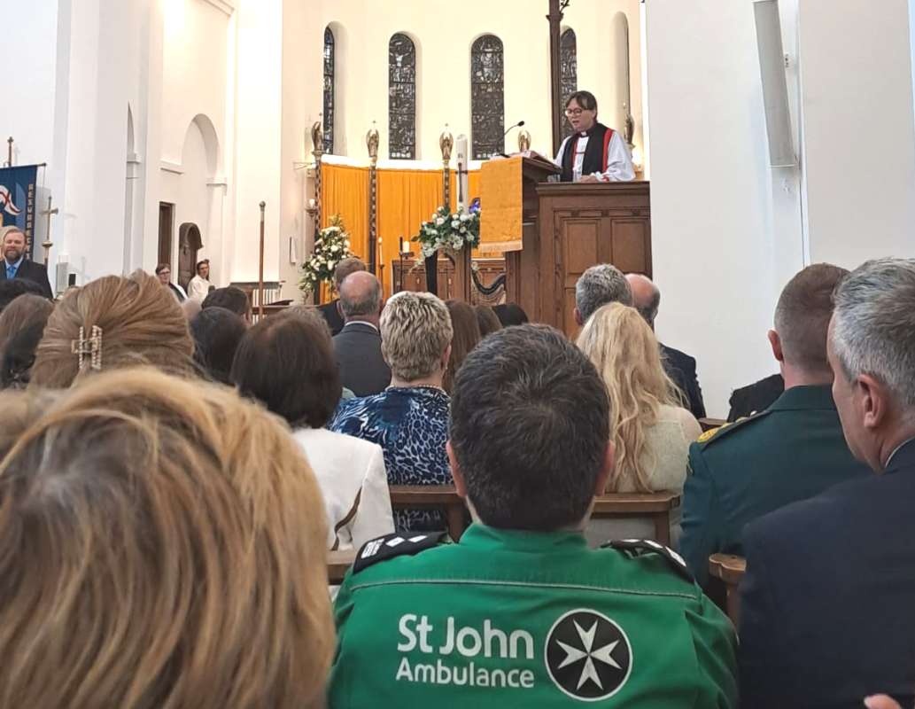 St John's Ambulance worker in audience of the 75th anniversary service of the NHS in Wales as Bishop Mary gives her sermon