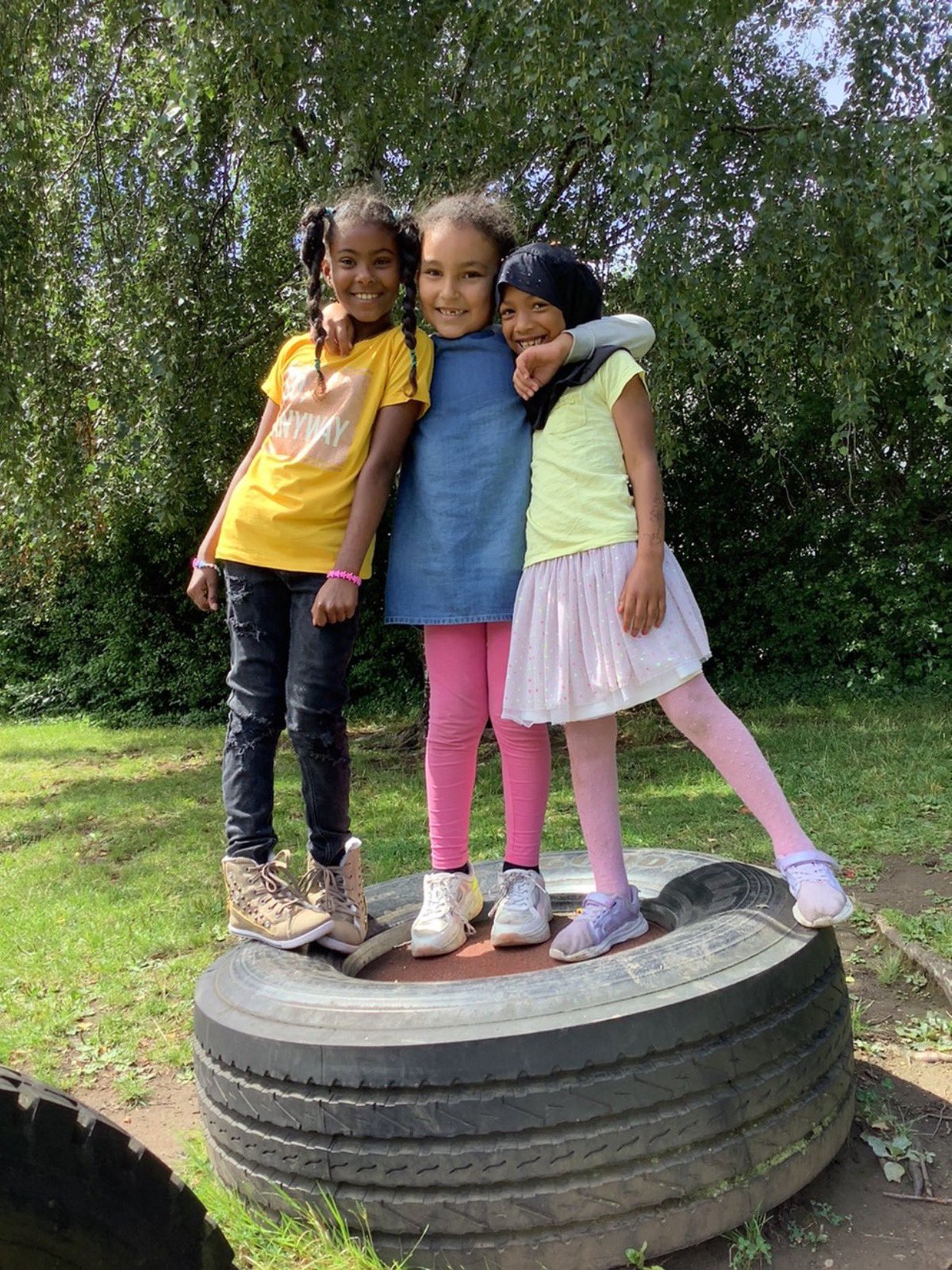 Pupils at St Mary's primary school standing on a tyre