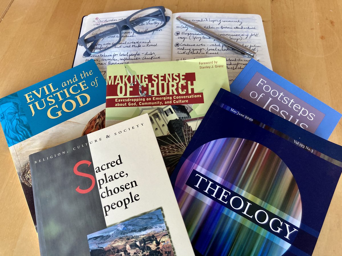 Selection of theology text books and a notepad