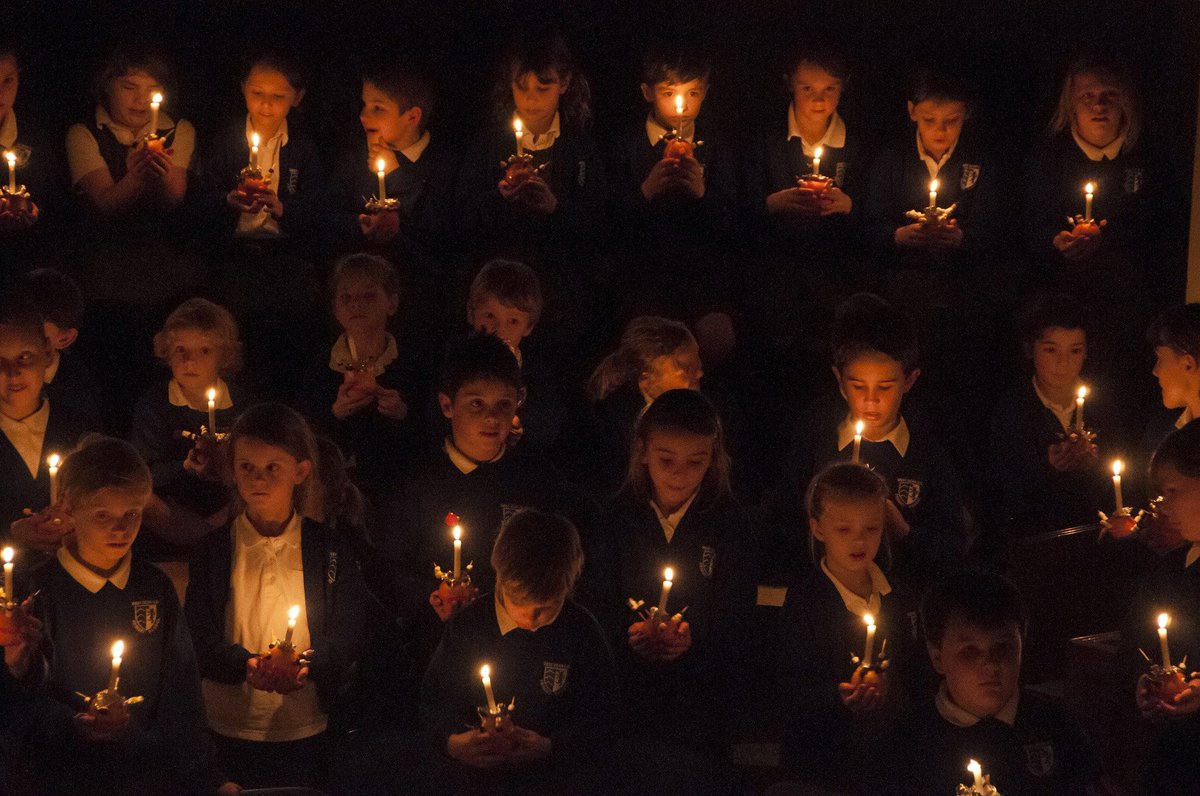 Group of children holding christingle candles