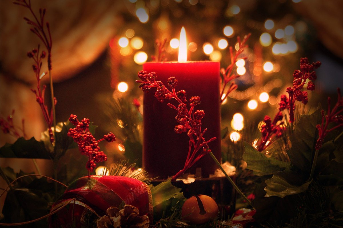 Red candle in the centre of a Christmas wreath