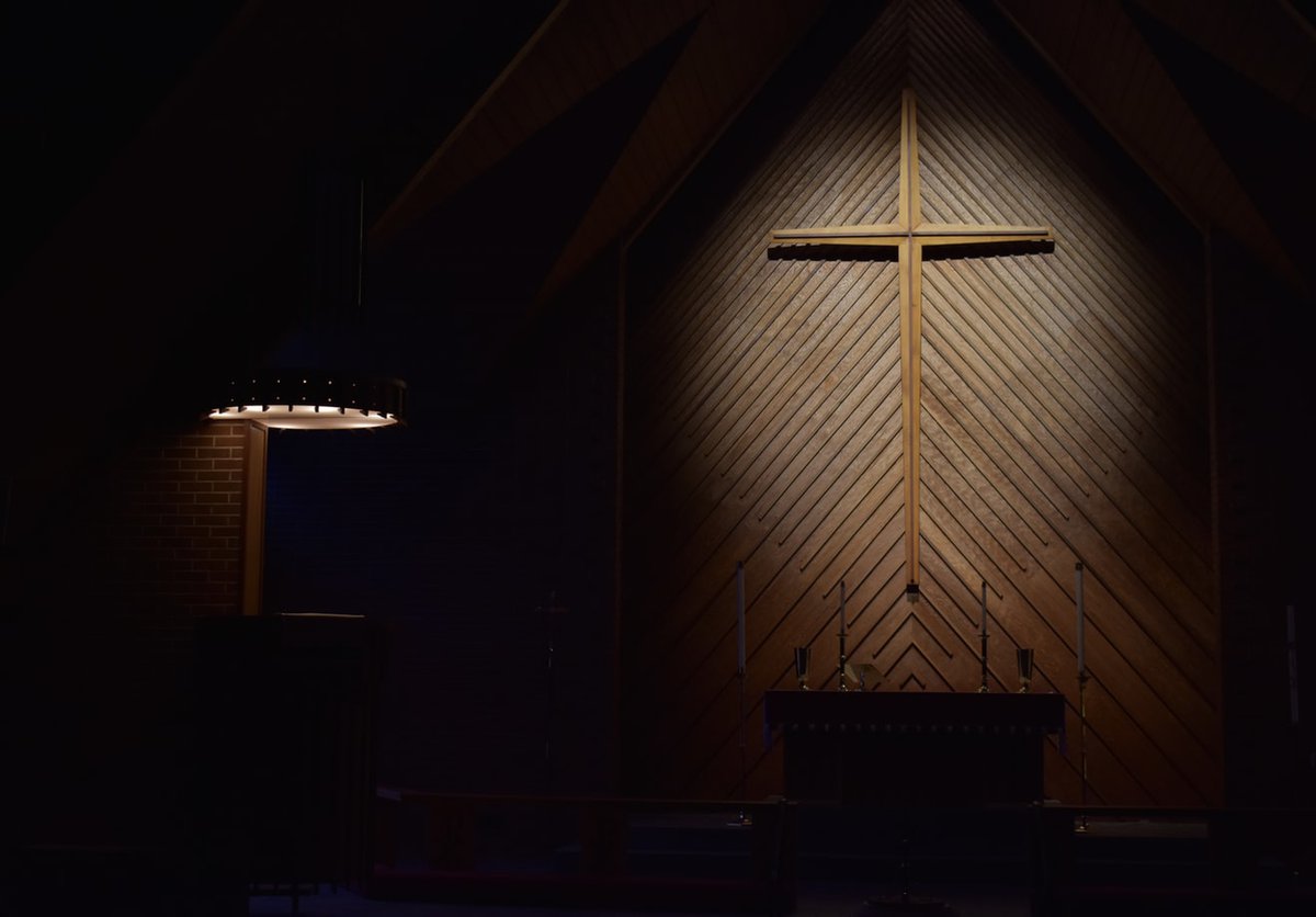 A cross hanging on a church's wall