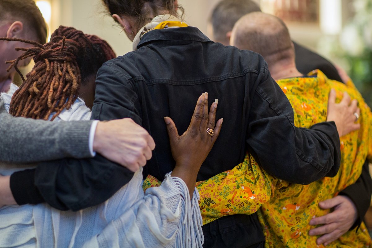 People hugging at a funeral