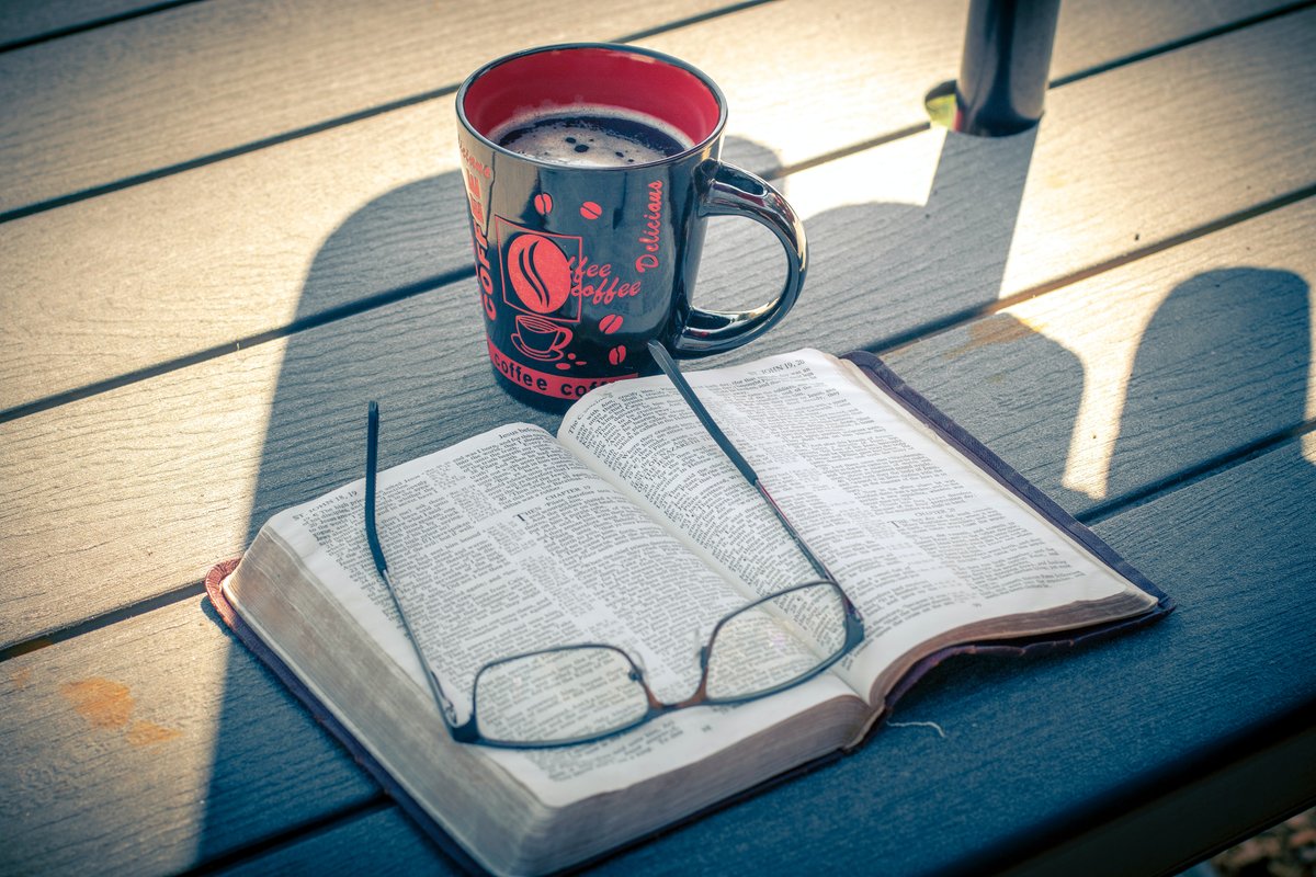 Coffee mug, bible and glasses